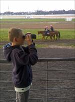 Charlie Holmes at the Flemington Jump Outs watching Observer